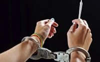 Image of handcuffs and marijuana